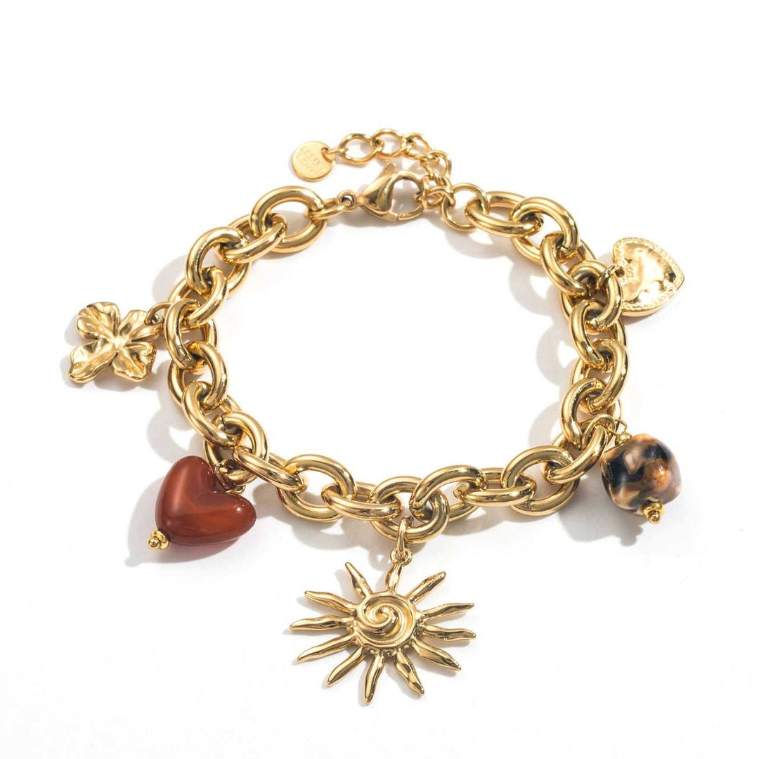 Bracelet doré à maillons épais en acier inoxydable avec breloques soleil, fleurs, cœurs et perle