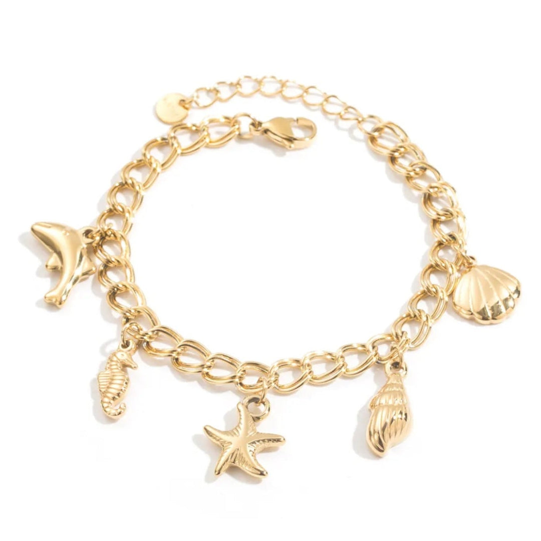 Bracelet marin doré en acier inoxydable avec charms coquillage, étoile de mer, hippocampe et dauphin pour femme.